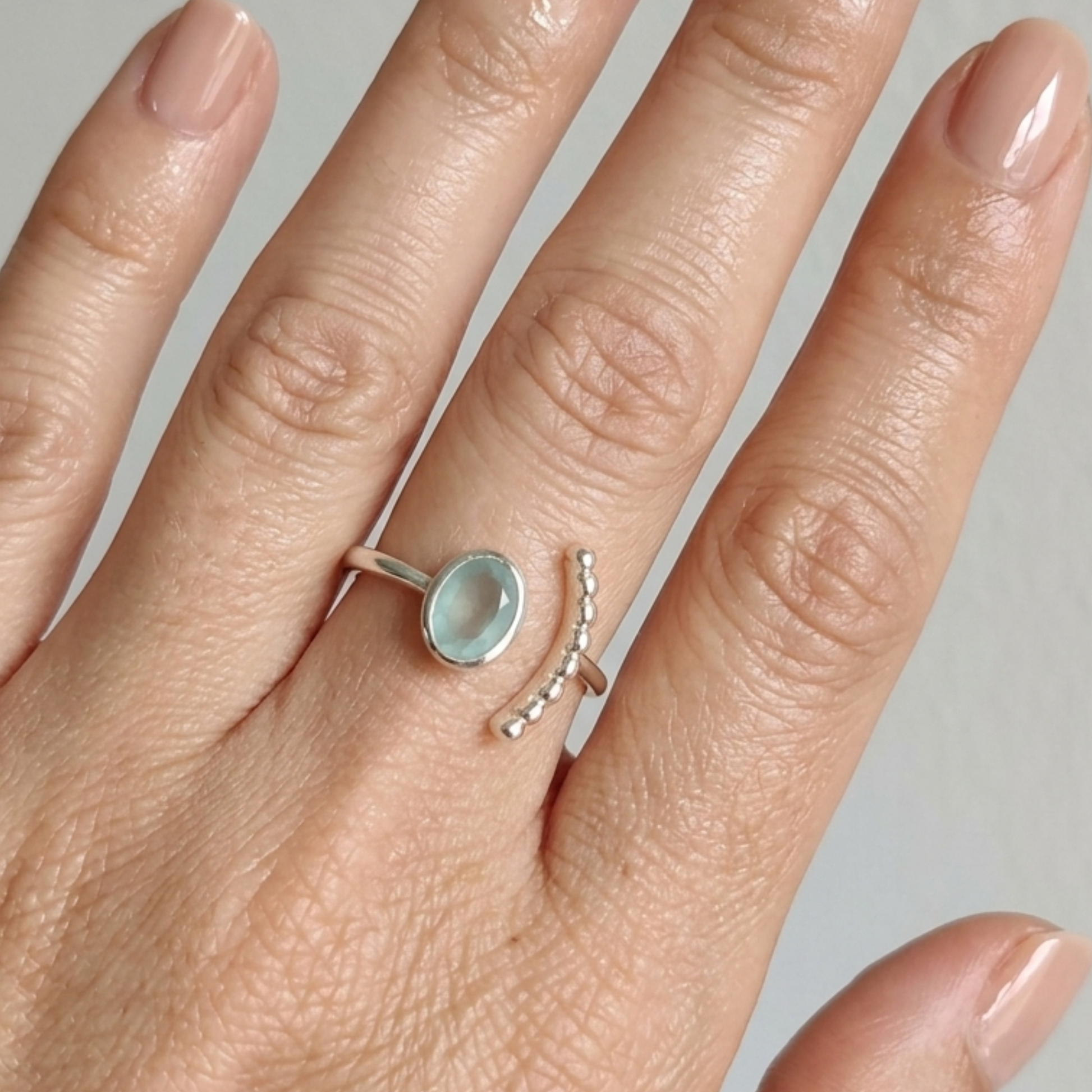 Modelo luciendo anillo NAÏS en la mano plata de ley con piedra aqua Ccazedonia