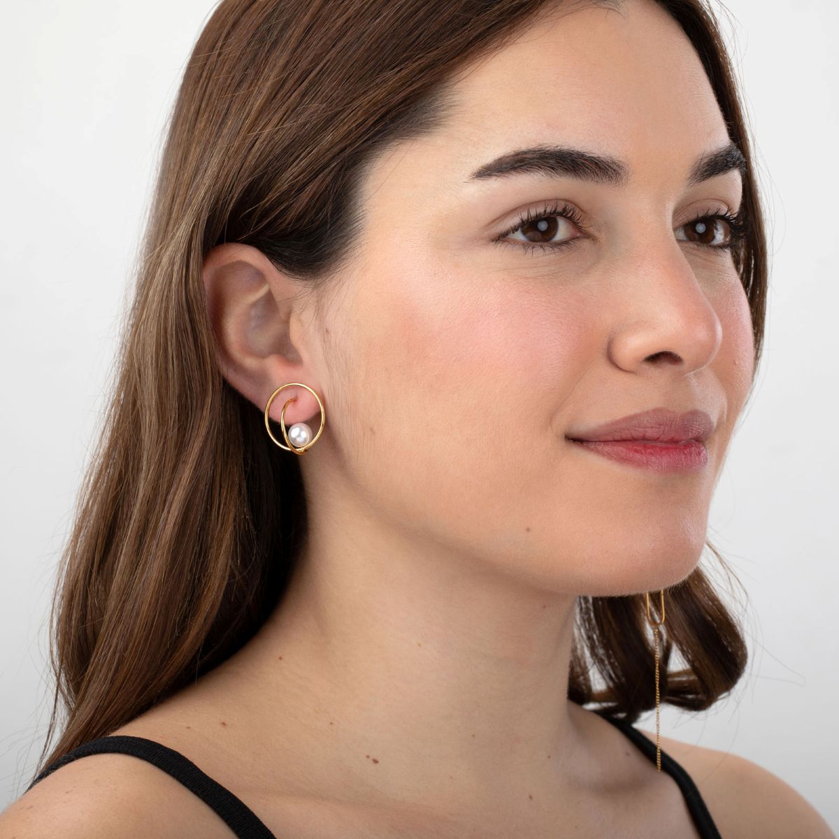 Modelo luciendo los pendientes Nuvola de MALBAE, una joya geométrica de acero resistente al agua ideal para eventos o diario.