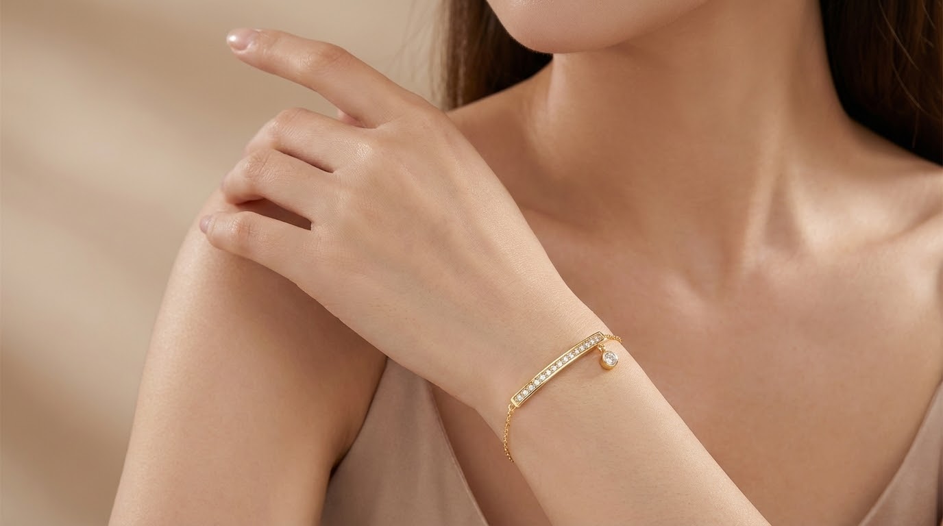 Modelo luciendo pulsera ÉLINE dorada con circonitas en la muñeca
